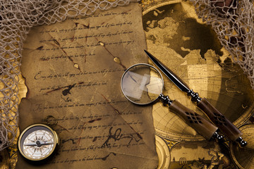 Fototapeta na wymiar Antique brass compass over old map