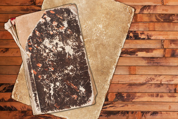 Aged book and paper on a wooden background
