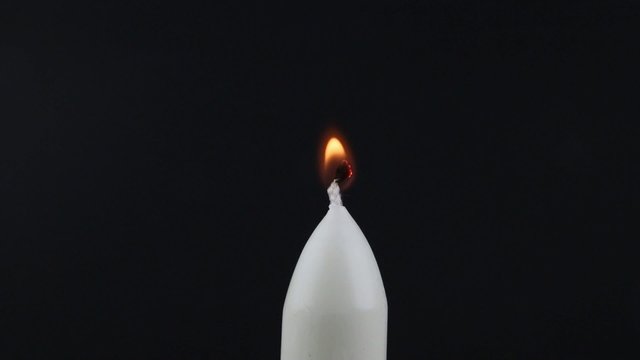 Candle being lit with a lighter