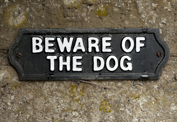 Beware of the dog sign screwed onto stone