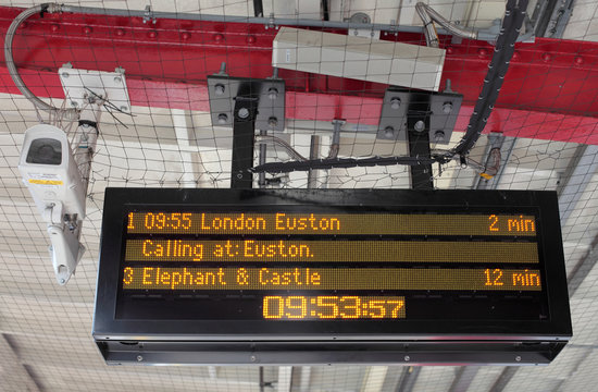 Electronic Timetable on London Railway Platform with Security Ca