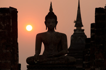 Silhouette of  Buddha in Sukhothai historical park in Thailand.