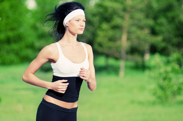 Fototapeta premium Woman running in green park