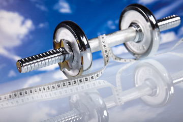 Fitness, dumbell and blue sky