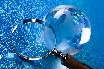 Travelling, magnifying glass and globe