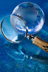 Travelling, magnifying glass and globe