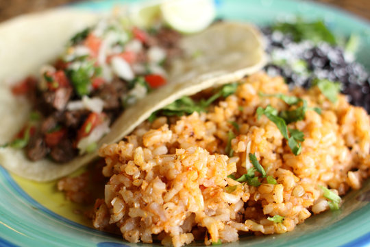 Steak soft taco with beans and rice.