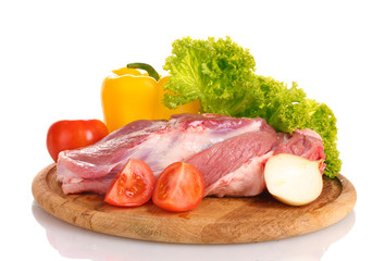 Raw meat and vegetables on a wooden board isolated on whitе
