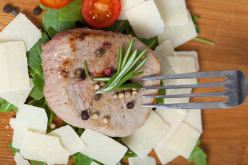 Cooked Beef on arugula and parmesan