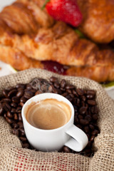 Hot coffee cup on toasted beans
