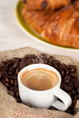 Hot coffee cup on toasted beans