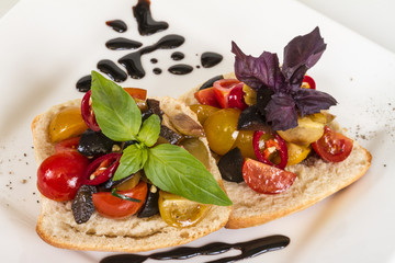 juicy tomatoes on fresh bread, pesto as topping