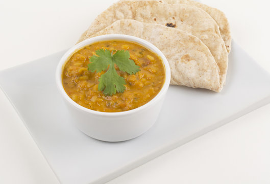 Tarka daal and chapati on a white background