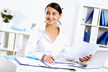 Young woman in business wear in office