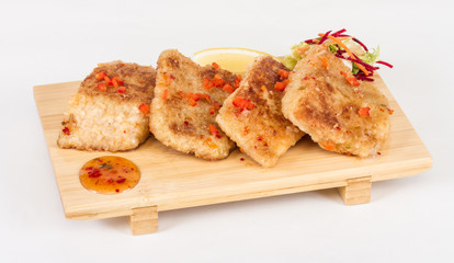 Fried fish fillets with  salad.