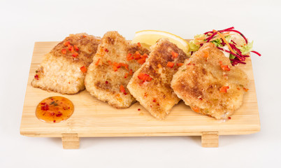 Fried fish fillets with  salad.