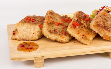 Fried fish fillets with  salad.