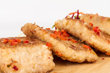 Fried fish fillets with  salad.