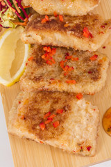 Fried fish fillets with  salad.