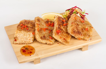 Fried fish fillets with  salad.