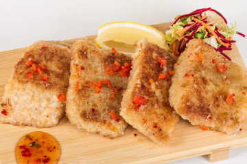 Fried fish fillets with  salad.