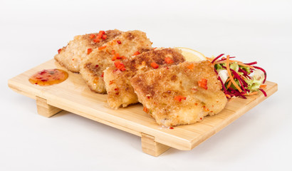 Fried fish fillets with  salad.