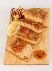 Fried fish fillets with  salad.