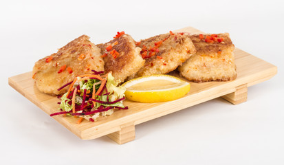 Fried fish fillets with  salad.