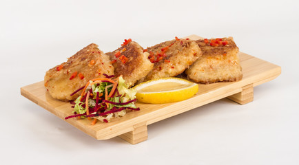 Fried fish fillets with  salad.