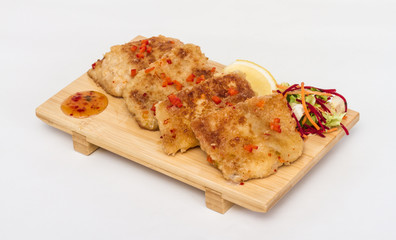 Fried fish fillets with  salad.