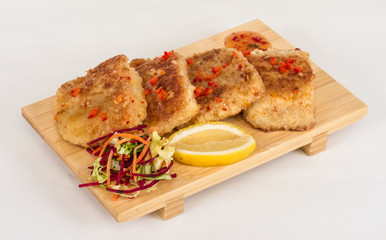 Fried fish fillets with  salad.