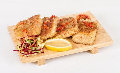 Fried fish fillets with  salad.