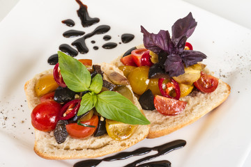 juicy tomatoes on fresh bread, pesto as topping