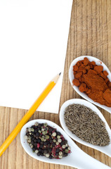 notebook for cooking recipes and spices on a wooden table