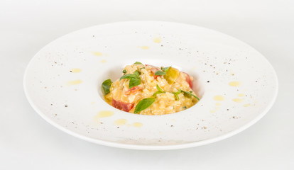 photo of delicious risotto dish with herbs and tomato on white b