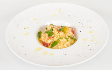 photo of delicious risotto dish with herbs and tomato on white b