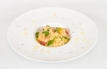photo of delicious risotto dish with herbs and tomato on white b
