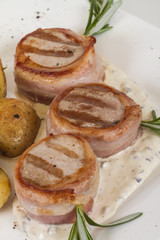 Grilled steak wrapped in bacon, with grilled vegetables, mashed