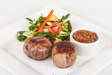 Grilled steak wrapped in bacon, with grilled vegetables, mashed