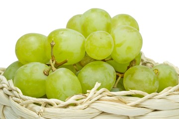 Close up of grapes in a basket on a white background
