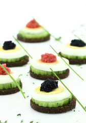 Canape  with cucumber, egg and caviar