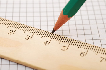 closeup wooden ruler and pencil on background