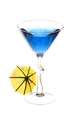 Wineglass are filled with blue beverage and cocktail umbrella