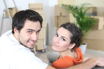 Couple surrounded by packing boxes