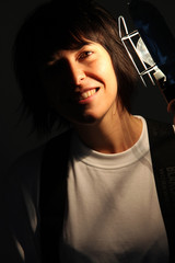Female electrician using electric lamp