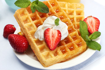 belgium waffles with honey, strawberries and mint
