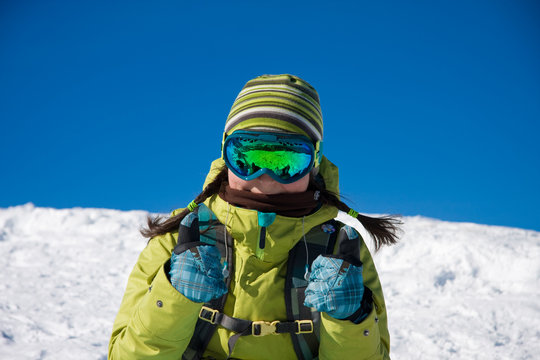 Snowboarder girl in bright clothes