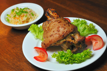 pork meat fried on grill with tomato and lettuce