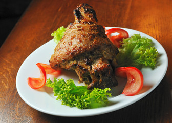 pork meat fried on grill with tomato and lettuce