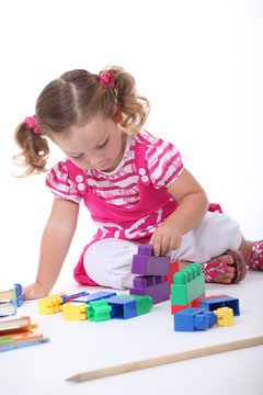 Little Girl Playing With Building Blocks